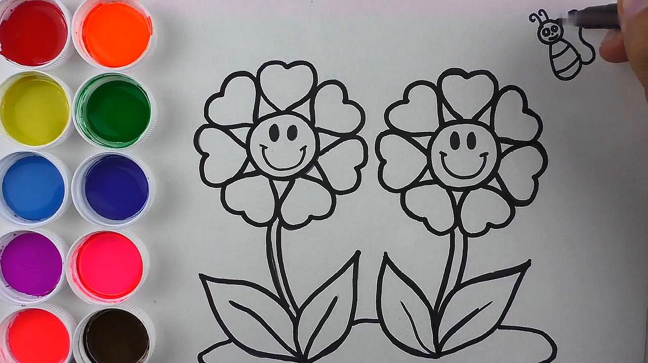 1爱心笑脸花朵:在中间画出一个笑脸,在周围画出爱心形状的花瓣,再
